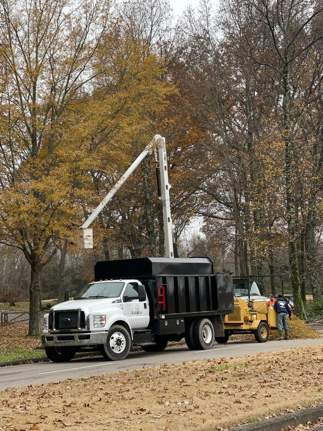 Bucket truck and chipper working a fall clearance job — Aaron&rsquo;s Tree Service, Mid-South